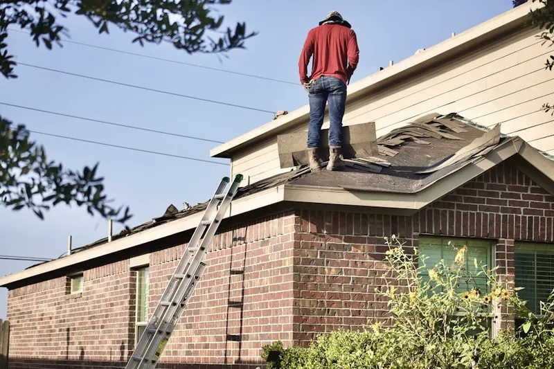 Professional roofer working on a residential roof in Land Park